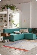 A modern teal sectional sofa with decorative pillows