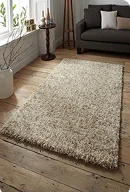 A plush beige shag rug on wooden flooring