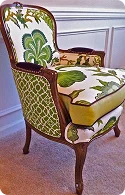 A stylish armchair upholstered in vibrant green botanical patterns