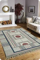 A stylish living room featuring a geometric patterned rug in neutral tones