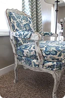 An elegant chair with a distressed wooden frame
