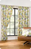 Brightly patterned curtains in green, blue