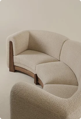 Curved beige sofa with textured fabric and wooden accents