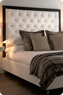 Elegant bed featuring a tufted white headboard