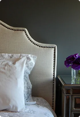 Elegant bed with a tufted beige headboard