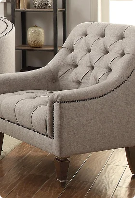 Elegant beige tufted armchair with nailhead trim