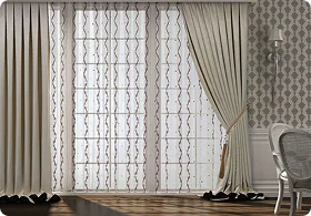 Elegant curtains frame a large window with intricate sheer drapes