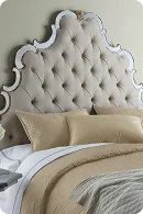 Elegant tufted beige headboard with ornate