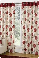 Floral-patterned curtains in red and cream adorn a large window