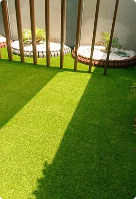 Lush green artificial grass shaded by wooden slats