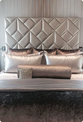 Luxurious bedroom scene featuring a diamond-patterned silver headboard