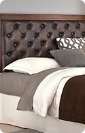 Luxurious brown tufted leather headboard with decorative pillows