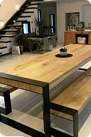 Modern dining area featuring a rustic wooden table with metal legs