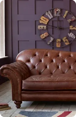 Brown tufted leather sofa in a cozy room