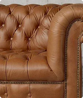 Close-up of a luxurious, tufted brown leather couch