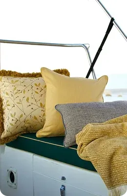 Three decorative pillows in yellow and grey