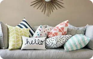 A colorful arrangement of decorative throw pillows on a light sofa