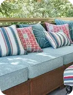 A cozy outdoor sofa adorned with colorful patterned pillows