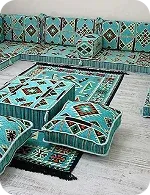 A cozy seating area featuring turquoise and patterned cushions