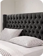 A stylish tufted gray upholstered headboard