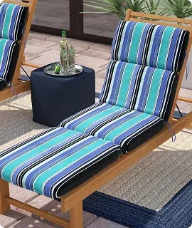 A vibrant blue and green striped lounge chair with a black cushion