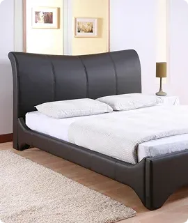 Black bed with headboard, two pillows, and white bedding