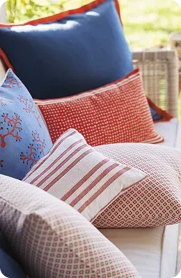 Colorful pillows with various patterns arranged on furniture