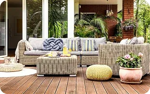 Cozy outdoor seating area featuring a woven sofa