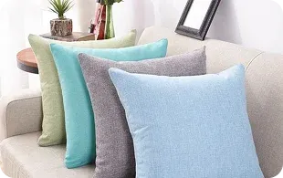 Four decorative pillows on a light-colored sofa