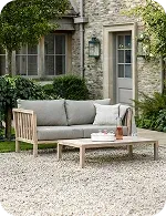Outdoor seating area with a sofa and coffee tableOutdoor seating area with a sofa and coffee table