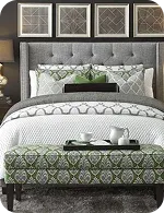 Stylish bedroom featuring a tufted gray headboard