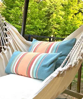 Two colorful striped cushions rest on a hammock