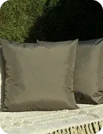 Two square cushions on a light-colored surface