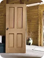 Wooden door with four panels in a room