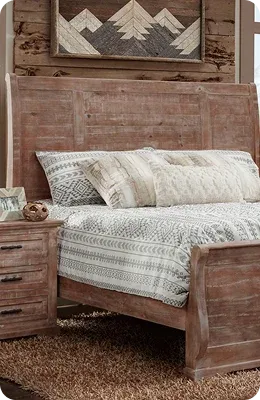 wooden bed with patterned bedding and nightstand